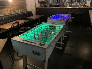 2 foosball together with different coloured lights