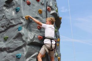 Climber going up the portable rock climbing tower