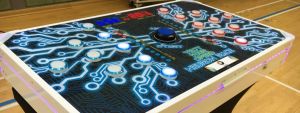 Closeup of a Neuron Race reaction game with LED buttons