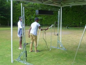 Boy playing on a giant steady hand game at a family fun day event.