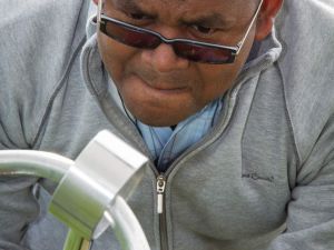 Close up of a man concentrating on the giant buzz wire game.