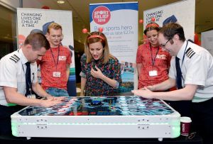 TV personality, Caroline Flack being a referee on a table based reaction game.