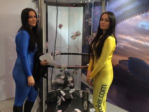 Two girls modelling a cash cube game at an exhibition.