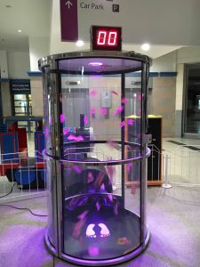 Try to catch the cash as it whirls around you