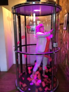Female player inside the grab a grand machine trying to grab as many tickets as she can.
