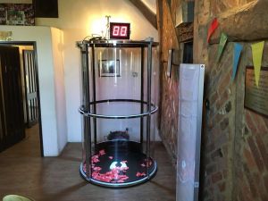Grab A Grand machine set up for an evening event alongside a magnetic scoreboard where times from the game are displayed.