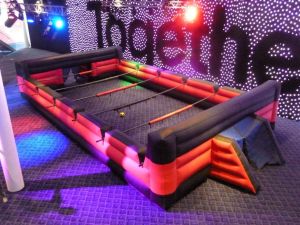 Inflatable human foosball table set up at Wembley Stadium for a conference event.