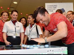 TV personality from The Only Way Is Essex playing on a Neuron Race reaction game.