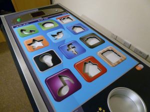 Tap The App steady hand game which is a giant mobile phone where players remove the app shaped pieces from the game without setting off the buzzer.