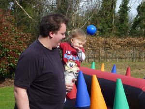 Dad and son enjoying playing on the inflatable air race game.