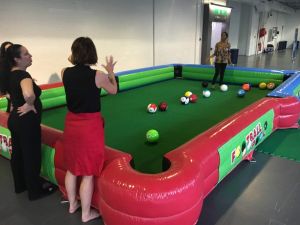 Female players enjoying a game within the inflatable football pool game.