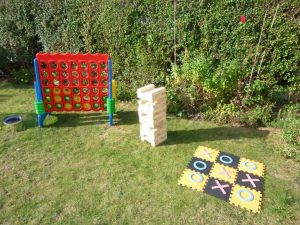 Giant Jenga, Connect 4 and Noughts and Crosses games set up for an event.