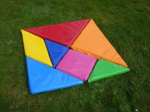 Giant tangram puzzle at a team building event where participants have created a square shape.