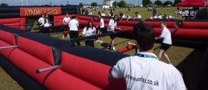 Xtreme Vortex team member supervising the human table football game