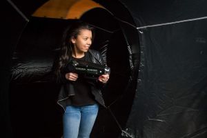Inflatable Laser Tag game being played by a female carrying a laser gun and shooting at an opponent.