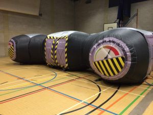 Inflatable Laser Tag Arena set up indoors in a sports hall for an event.