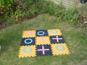 Giant noughts and crosses garden game set up for an event.