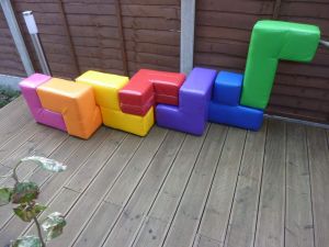 A giant soma cube assembled into a snake shape at a team building event.
