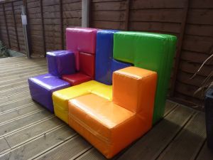 Giant soma cube puzzle assembled into a sofa shape.
