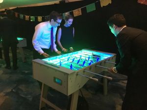 Table Football at an evening event at an indoor location.
