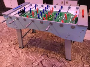 Table football is a pub game set up for an event at a hotel conference room.