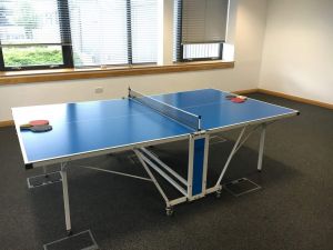 Table Tennis within a corporate office function room for an event.