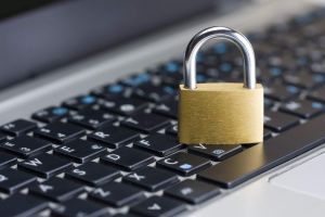 Close up of a computer keyboard and a padlock
