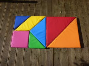 Tangram Puzzle assembled into a rectangular shape at a team building event.