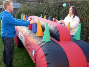 Inflatable under pressure game played by a male and female at an event.