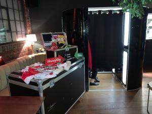 Classic black skin enclosed photo booth set up with christmas props