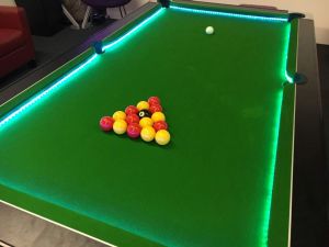 Pool Table with a green playing surface and LED lights around the outside of the game.
