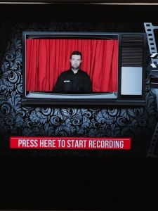 Screen shot of a person sitting in the video booth, ready to record.