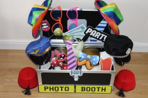 Prop box for a photo booth containing hats, silly glasses and funny lips.