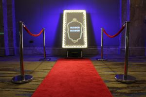 Selfie Mirror Photo Booth with red carpet and Led lights on a the mirror frame.