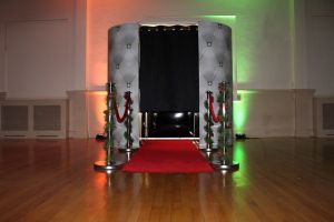 Christmas Theme Photo Booth includes Red Carpet and Christmas Posts.