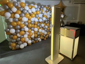 balloon background with selfie booth and printing station