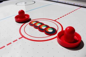 Air hockey pucks with branded stickers