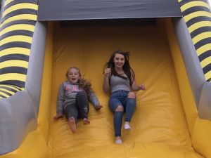 Girls, sliding down the slide on the Obstacle Course