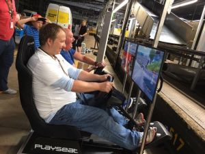 Guests playing racing simulator seats