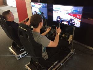 2 Guests playing on the Racing Simulators