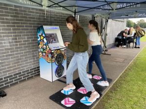 2 friends dancing on the dance machine