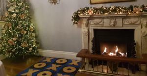 Noughts and Crosses set up by a Christmas tree and fireplace