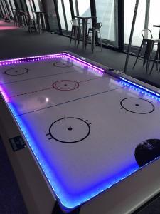 purple and blue 2 toned air hockey LED table