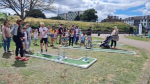 People using the mini golf